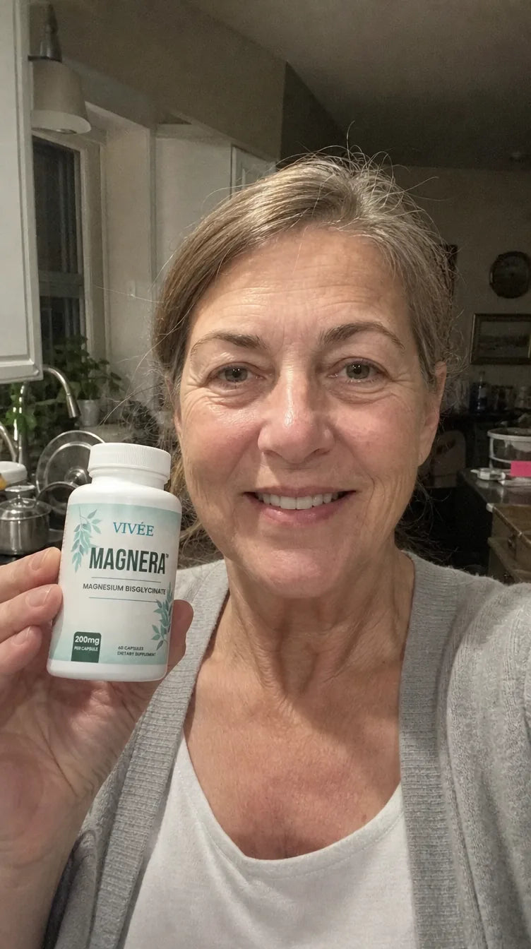 Demo review photo: a woman in her kitchen holding a bottle of Vivée Magnera